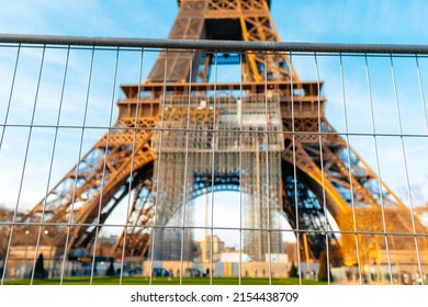 View of Eiffel Tower through security fence. Access forbidden.
