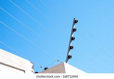 View of an electric fence installation on a concrete wall - Shutterstock ID 168712496