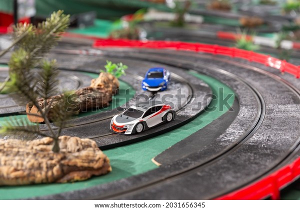 View of electric slot cars on the toy race track\
ready to play