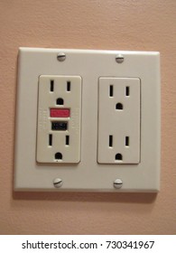 Electrical outlet with reset button