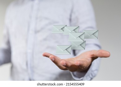 A View Of Email Icons Floating In Palm Of Male In White Shirt