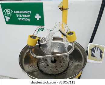 View of an emergency eye wash station complete with the safety signage - Shutterstock ID 703057111