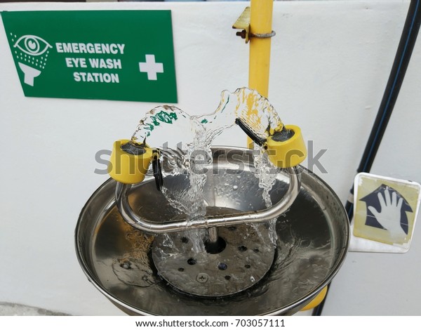 View of an emergency eye wash station complete\
with the safety signage