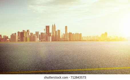 View of the empty asphalt road with city skyline background  . Sunset sunrise scene . - Shutterstock ID 712843573