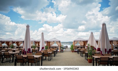 View Of Empty Beach Cafe Restaurant. Corona Of COVID-19 Virus Quarantine Lockdown. Beach Cafe Without Visiting, People. Chair, Table At Seaside, No Tourist. Travel Ban In Europe. Tourist Season.