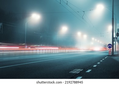 View empty dark night blue foggy misty rainy highway city road backlight red traces low poor visibility cold spring autumn season. Seasonal bad rainy weather accident danger warning car fog light - Shutterstock ID 2192788945