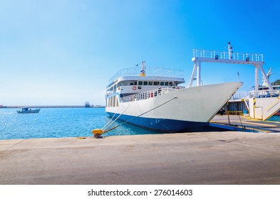 View of empty ferry in typical Greek blue white colors waiting in harbour to be loaded with cars 