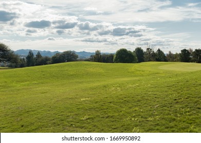 View of empty golf course with Cordoba Argentina mountain ranges and trees