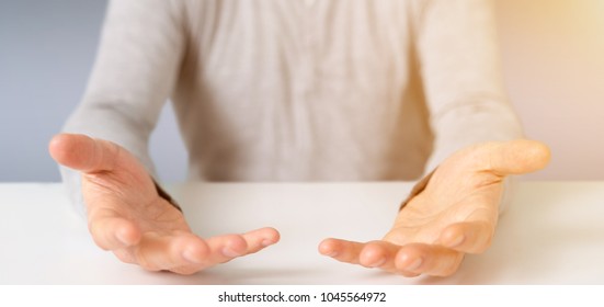 View of Empty holding hands of a young relaxed man over a desk