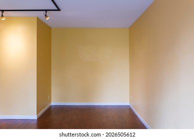 View of empty living room in a modern new apartment condo house interior with empty yellow walls.