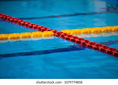 The View Of An Empty Public Swimming Pool Indoors. Lanes Of A Competition Swimming Pool