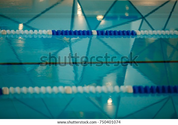 The view of an empty\
public swimming pool indoors lanes of a competition swimming pool\
sport 