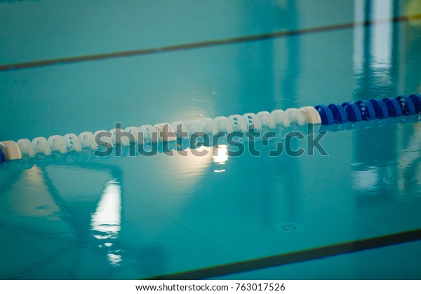 The view of an empty
public swimming pool indoors lanes of a competition swimming pool
sport 