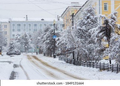 View of an empty snow-covered city street during a snowfall. Snowy road. Fresh white snow on tree branches. Cold snowy winter weather. City of Magadan, Magadan Region, Siberia, Far East of Russia. - Shutterstock ID 1849131664