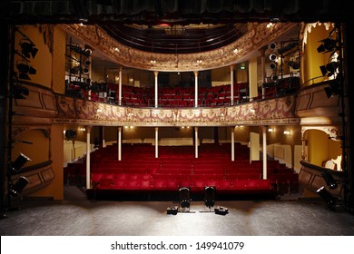 View Of An Empty Theatre With Red Seats And Balcony