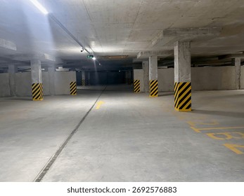 View of empty underground parking with dedicated spots