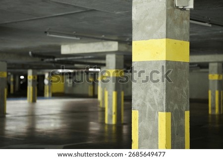View of empty underground parking with dedicated spots
