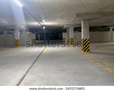 View of empty underground parking with dedicated spots