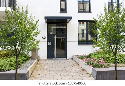 View To Entrance Door Of A Modern Residential Building With New Apartments In The City