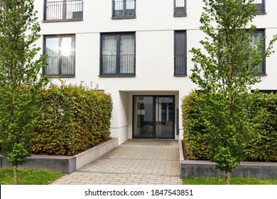 View To Entrance Door Of A Modern Residential Building With New Apartments In The City