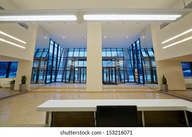 View At Entrance Door Of Office Building From Reception Desk.