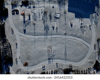 view of exercise zone of fitpark. a new project to maintain a slim figure. gym muscles on machine. movement exercise. running and stretching, early in the morning. snow cover unifies surface - Powered by Shutterstock