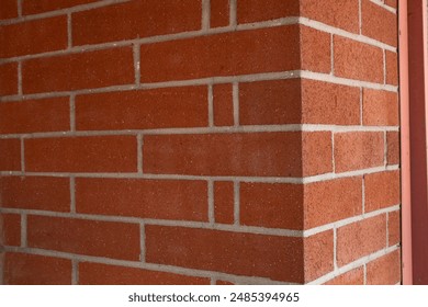 A view of an external angle of a brick wall. 