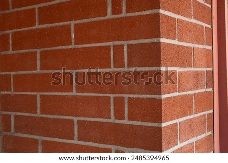 A view of an external angle of a brick wall. 