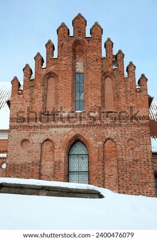 The view of the facade of a medieval building partially covered by deep snow in Kaunas old town (Lithuania).