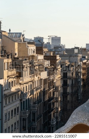 A view of the facades and roofs of a street in Barcelona. Typical Spanish residential buildings of the beginning of the 20th century.