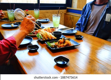 View Of A Family Enjoying Japanese Food In The Restaurant,concept Of Family Reunion