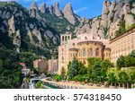 View the famous Catholic monastery of Montserrat on the background of round rocks. Blue sky. Catalonia, Spain.