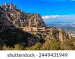 View of the famous Santa Maria de Montserrat Abbey located on the mountain of Montserrat nearby from Barcelona in Catalonia, Spain. Montserrat Monastery