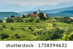 View of famous wine region Goriska Brda hills in Slovenia. Panoramic photo of villages of Gorica Hills with vineyards and grapevine covering hills. Agricultural wine region of Slovenia.