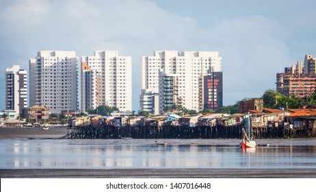 View of Favela Slum in Sao Luis de Maranhao. Brazil Skyline of the City behind. River mangrove. Contrast concept of poverty and inequality.