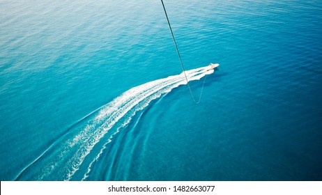 View Of Feet Parasailing With The Speed Boat In The Sea Background.