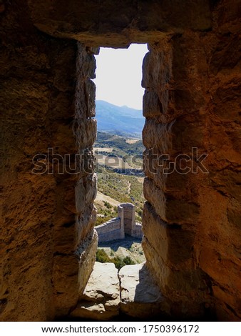 View of the field from a arrowslit window in the Castle of Loarre. Aragon. Spain. 
