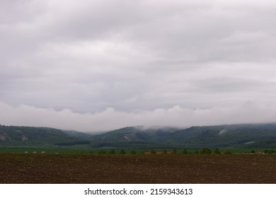 View of a field with stormy clouds