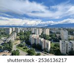 The view from the fifteenth floor looking at other buildings, mountain and blue sky with some white clouds in Sofia Bulgaria.