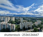 The view from the fifteenth floor looking at other buildings, mountain and blue sky with some white clouds in Sofia Bulgaria.