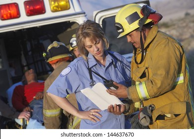 View of fire fighters and paramedics assisting injured man - Powered by Shutterstock
