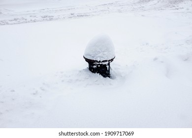 A view of a fire hydrant covered in snow