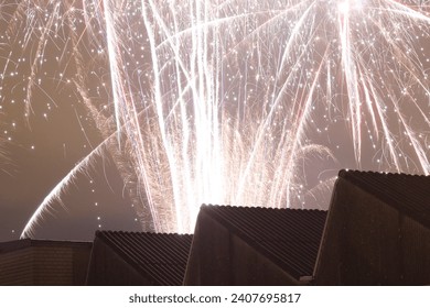 view of firework exploding over a factory roof - Powered by Shutterstock