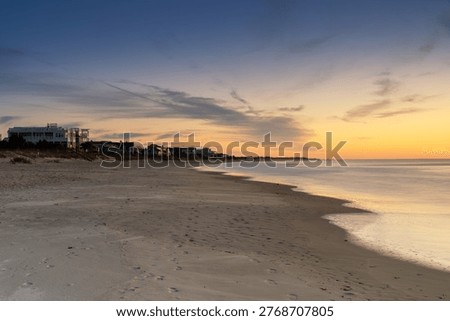 A view of the first row homes and endless beach of Pawleys Island at sunrise