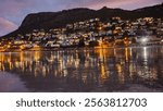 View from Fishhoek beach of lights reflecting on the water at Simonstown 