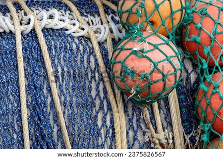 View of fishing nets rolled up on the large drum of a fishing boat.