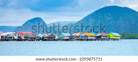 View of a fishing village in Thailand. Village on the water, cottages on stilts. Sea Gypsies in Phang Nga Bay. An exotic tourist destination with an unusual infrastructure.