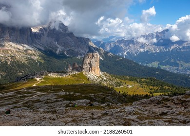 View of Five Towers Peaks (Cinque Torri), dolomitic mountain group under a cloudy sky, Italy.