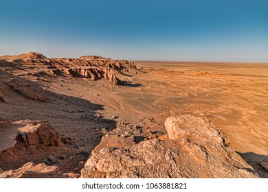 View of Flaming Cliffs in Mongolian Gobi Desert. Panoramic View of Cliffs and Surrounded Arid Plains.