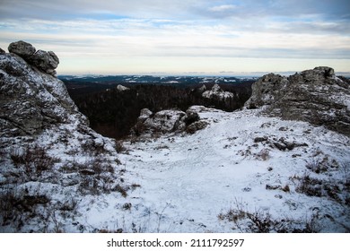 View at flat summit at hill top in winter, Rocks and plants covered with snow, Snowy winter landscape